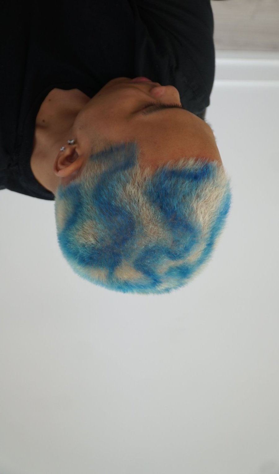 Blue colour work on a buzz cut at fyf North