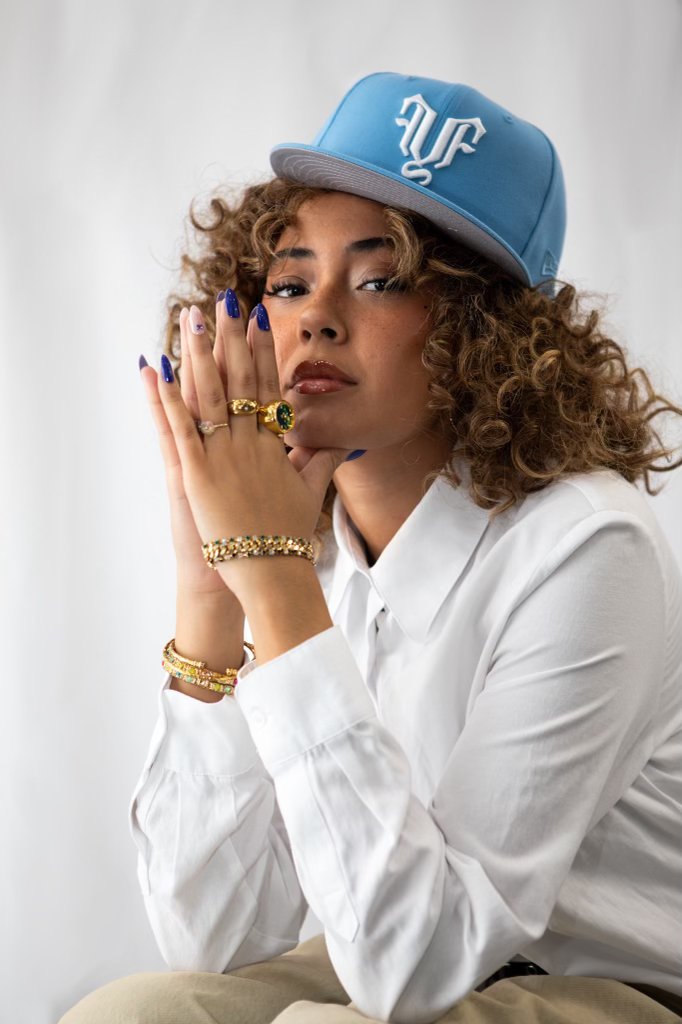 Client with curly hair and an LA cap at fyf North