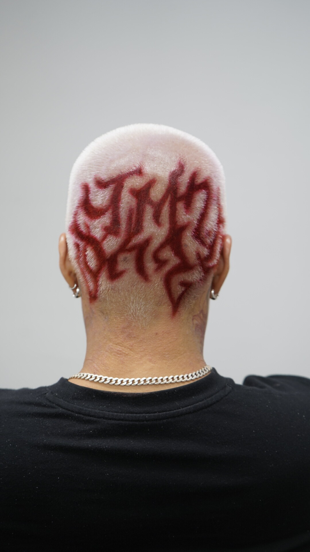 Platinum buzz cut with a red fyf design carved into the hair at FYF NORTH