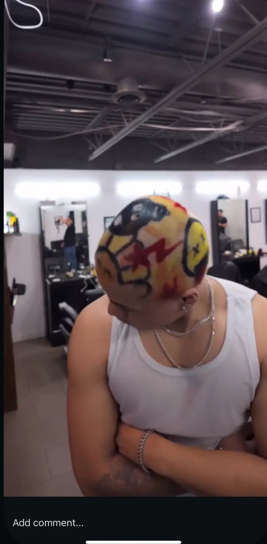 Smiley-face colour design on a buzz cut in the studio at fyf North