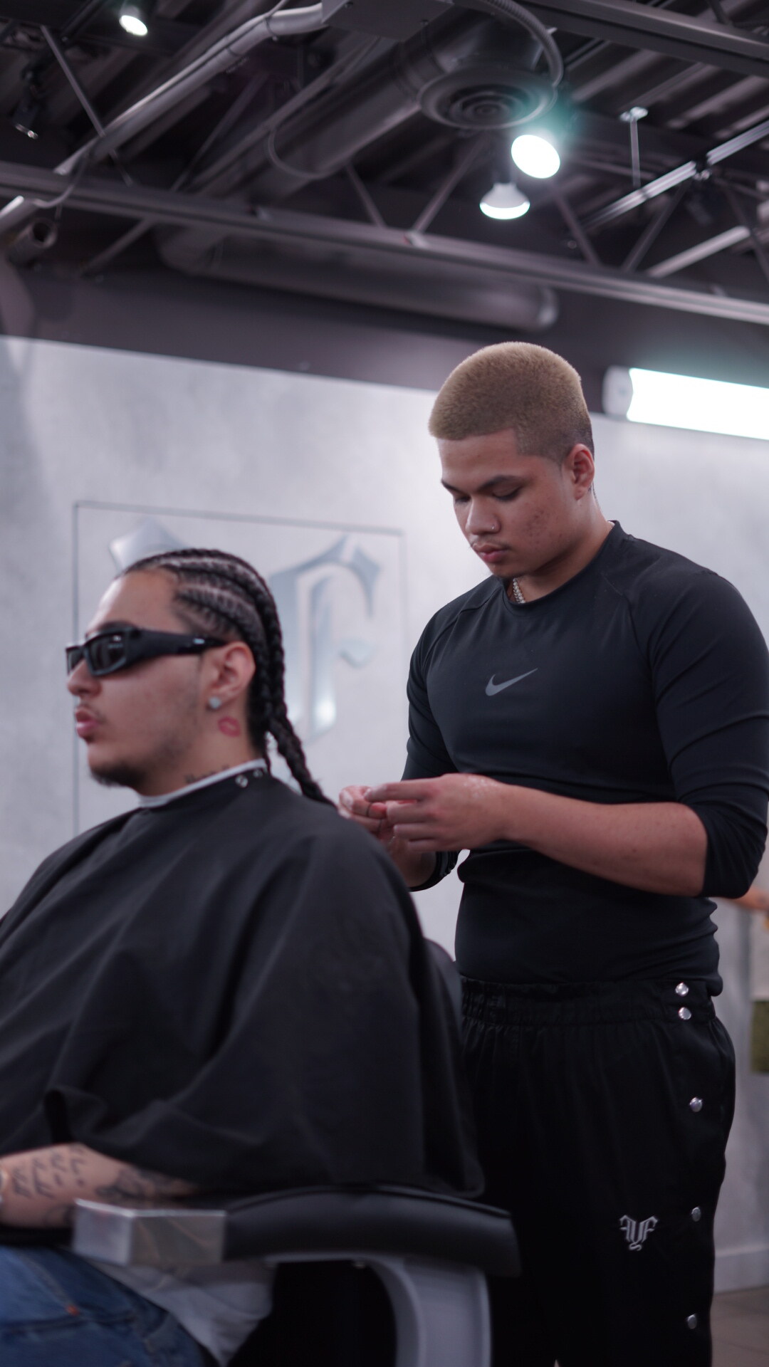 Barber finishing a fresh fade in the studio at fyf North
